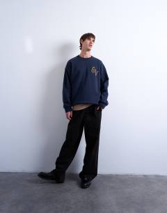 Model wearing Oversized fit sweatshirt with East Village embroidery in navy
