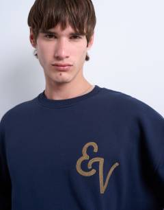 Model wearing Oversized fit sweatshirt with East Village embroidery in navy