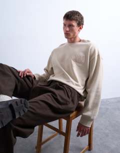 Model wearing Oversized fit sweatshirt with raised floral print in stone