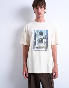 Model wearing Oversized fit t-shirt with doorway image print and embroidery in ecru