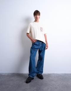 Model wearing Oversized fit t-shirt with floral line drawing embroidery in ecru