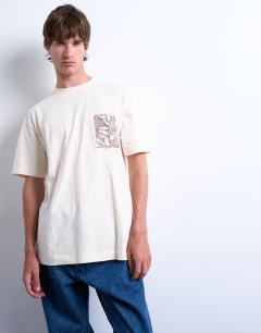 Model wearing Oversized fit t-shirt with floral line drawing embroidery in ecru