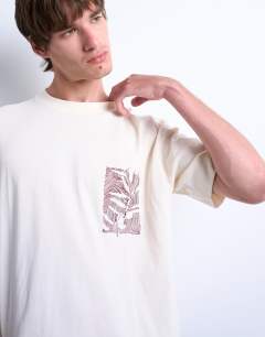 Model wearing Oversized fit t-shirt with floral line drawing embroidery in ecru