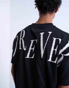 Model wearing Oversized fit t-shirt with Forever embroidery in black