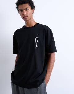 Model wearing Oversized fit t-shirt with Forever embroidery in black