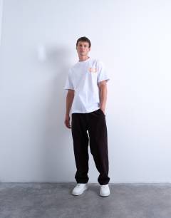 Model wearing Oversized fit t-shirt with front and back bird doodle print and embroidery in white