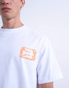 Model wearing Oversized fit t-shirt with front and back bird doodle print and embroidery in white