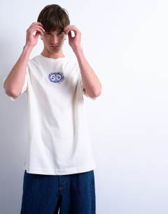 Model wearing Oversized fit t-shirt with front and back Cala Carbo print in ecru