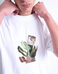 Model wearing Oversized fit t-shirt with front and back collage floral print in white