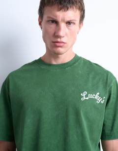 Model wearing Oversized fit t-shirt with front and back lucky print in washed green