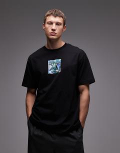 Model wearing Oversized fit t-shirt with front and back painted face graphic in black