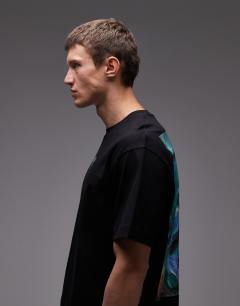 Model wearing Oversized fit t-shirt with front and back painted face graphic in black