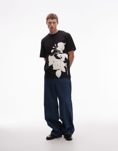 Model wearing Oversized fit t-shirt with mono floral print in black