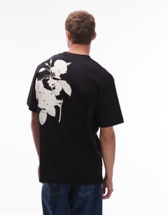 Model wearing Oversized fit t-shirt with mono floral print in black