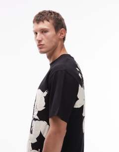 Model wearing Oversized fit t-shirt with mono floral print in black