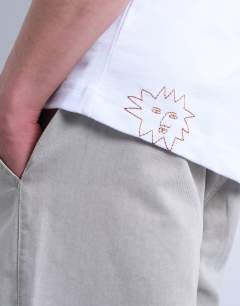 Model wearing Oversized fit t-shirt with sun doodle print and embroidery in white
