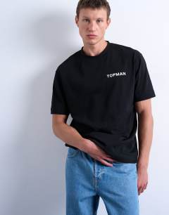 Model wearing Oversized fit t-shirt with Topman front & back print in black