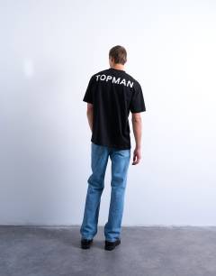 Model wearing Oversized fit t-shirt with Topman front & back print in black