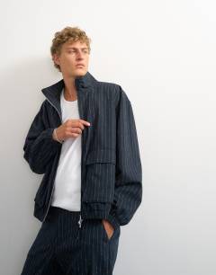 Model wearing Oversized fit tailored funnel neck bomber with boucle pinstripe in navy