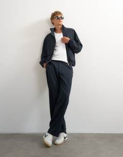 Model wearing Oversized fit tailored funnel neck bomber with boucle pinstripe in navy