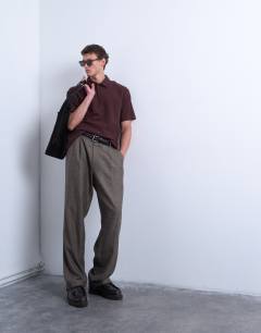 Model wearing Oversized fit textured interlock polo in brown