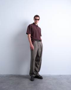 Model wearing Oversized fit textured interlock polo in brown