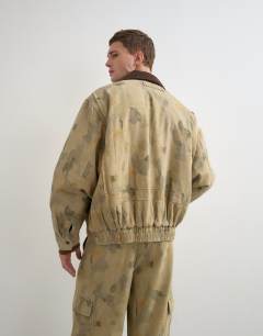 Model wearing Oversized fit twill camo print bomber jacket with cord collar in khaki