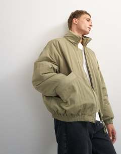 Model wearing Oversized fit twill nylon funnel neck bomber jacket in khaki