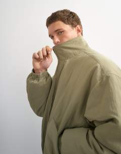 Model wearing Oversized fit twill nylon funnel neck bomber jacket in khaki