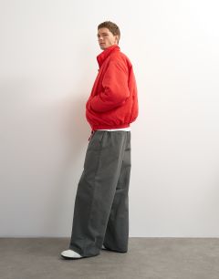 Model wearing Oversized fit twill nylon funnel neck bomber jacket in red