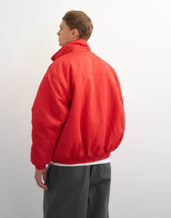 Model wearing Oversized fit twill nylon funnel neck bomber jacket in red