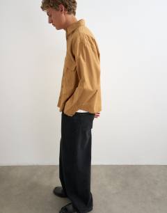 Model wearing Oversized fit utility shirt in tan