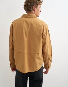 Model wearing Oversized fit utility shirt in tan
