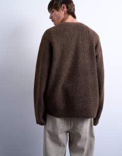 Model wearing Oversized fit v neck jumper in brown