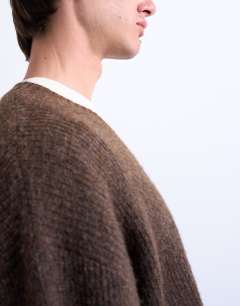 Model wearing Oversized fit v neck jumper in brown