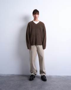 Model wearing Oversized fit v neck jumper in brown
