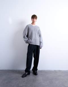 Model wearing Oversized fit v neck jumper in grey