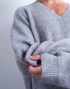 Model wearing Oversized fit v neck jumper in grey