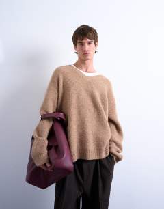 Model wearing Oversized fit v neck jumper in stone