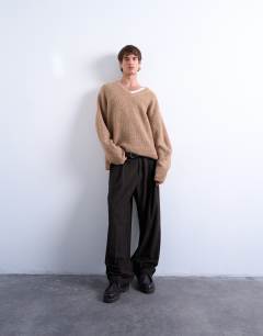 Model wearing Oversized fit v neck jumper in stone