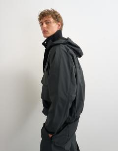 Model wearing Oversized fit waterproof nylon utility jacket in black