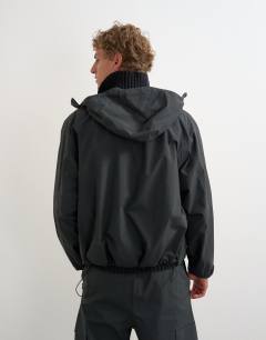 Model wearing Oversized fit waterproof nylon utility jacket in black