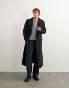 Model wearing Oversized fit wool mix boucle double breasted overcoat in black