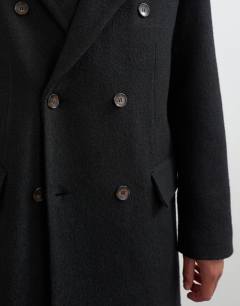 Model wearing Oversized fit wool mix boucle double breasted overcoat in black
