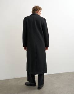 Model wearing Oversized fit wool mix boucle double breasted overcoat in black