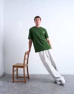 Model wearing Oversized Shibuya print t-shirt in dark green