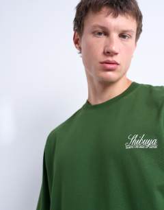 Model wearing Oversized Shibuya print t-shirt in dark green