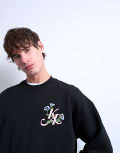 Model wearing Oversized sweatshirt with monogram floral embroidery in black
