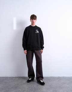 Model wearing Oversized sweatshirt with monogram floral embroidery in black