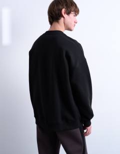 Model wearing Oversized sweatshirt with monogram floral embroidery in black